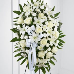 This exquisite standing spray in white and green includes roses