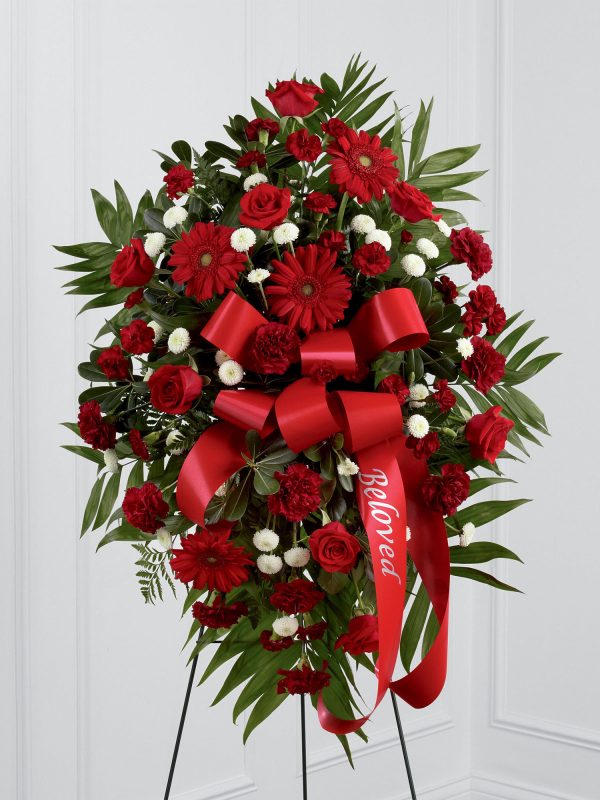 This beautiful standing spray is a rich and colourful way to express your love and devotion. A stunning arrangement in shades of red includes roses